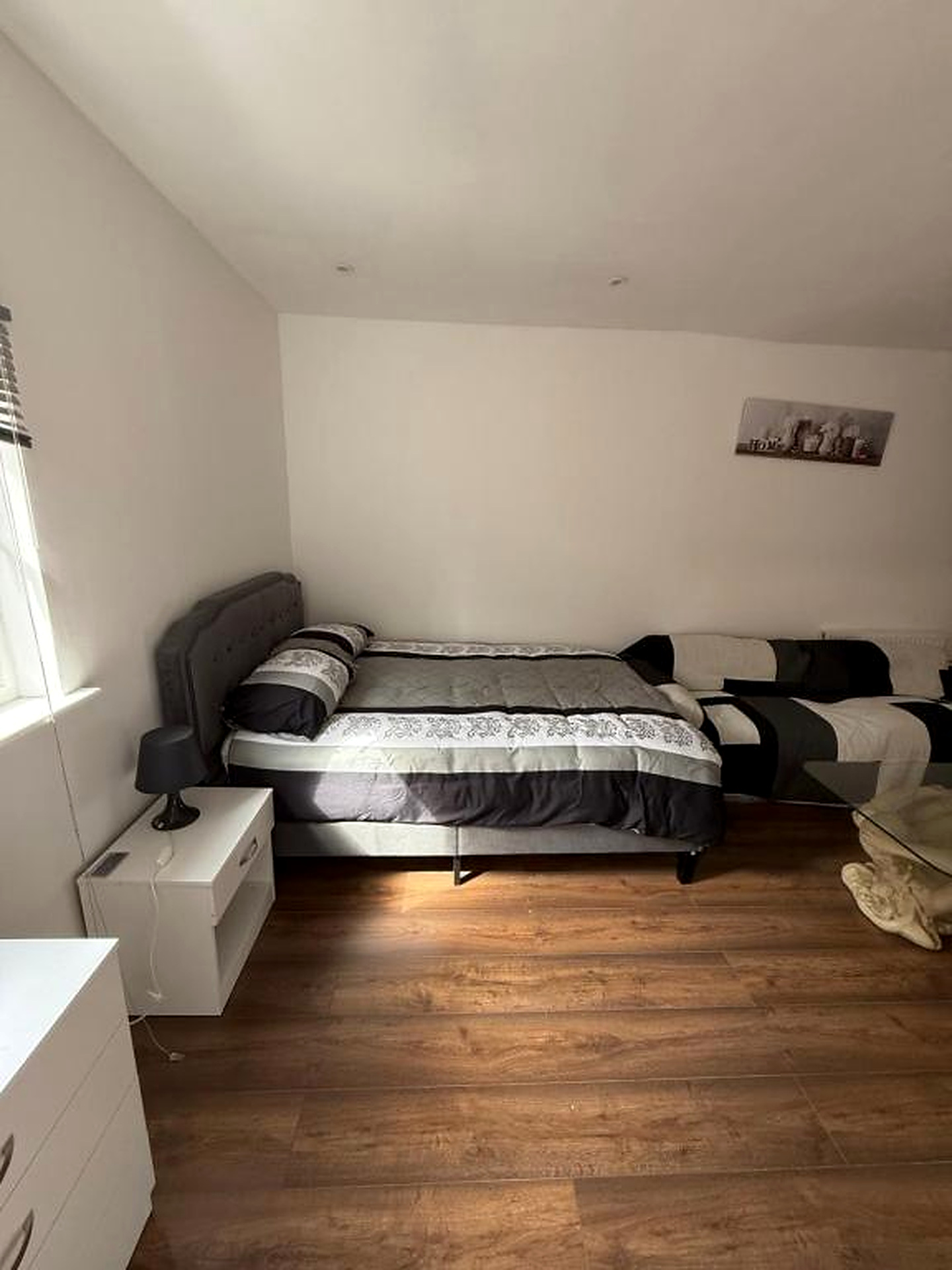 Bedroom with a double bed and wooden floor