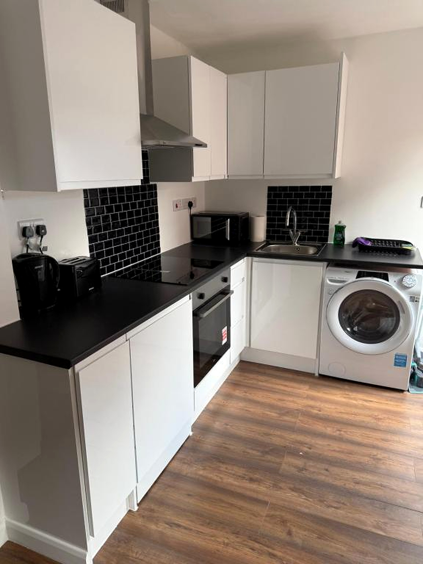 White kitchen cabinets with a washing machine