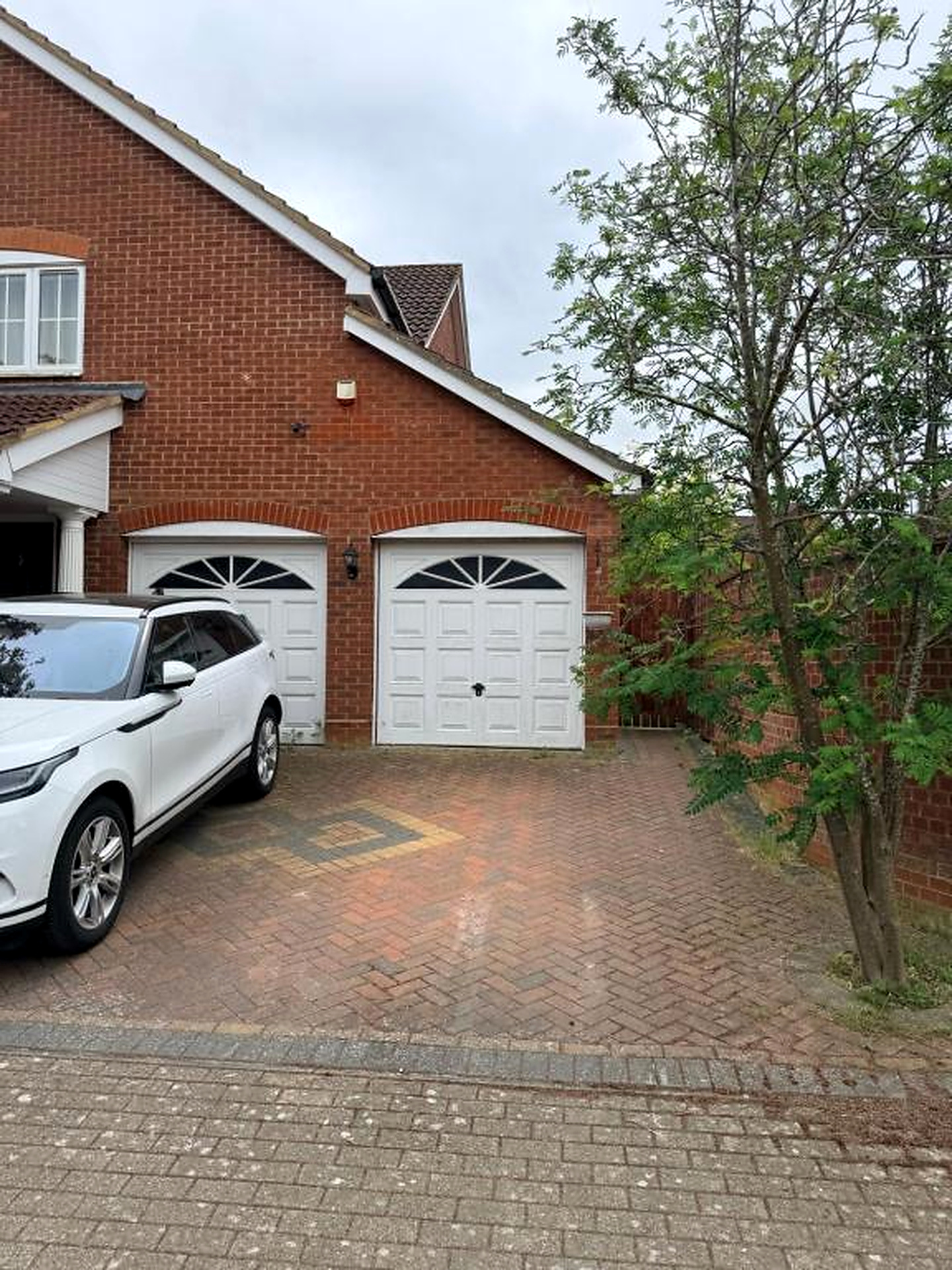 Car parked in front of the brick house
